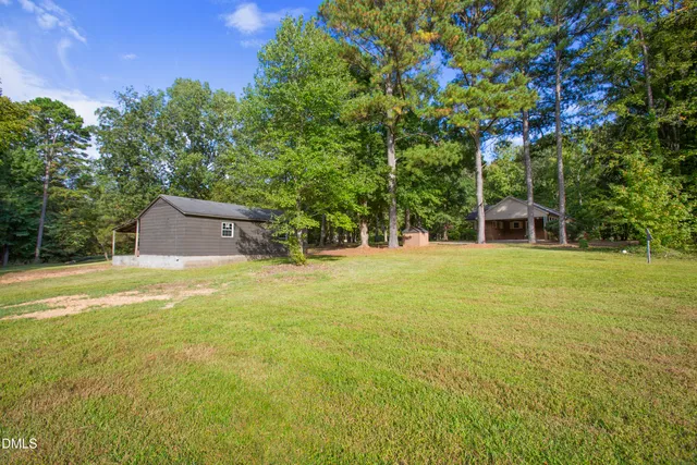 a swimming pool with outdoor seating and yard
