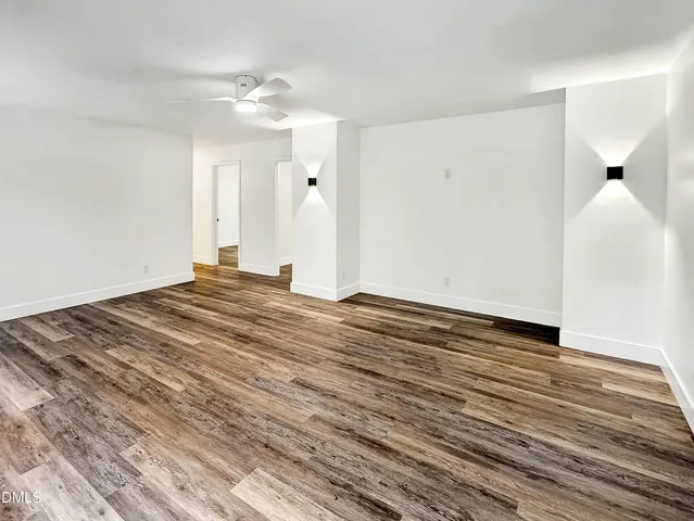 a view of a livingroom with wooden floor and a ceiling fan