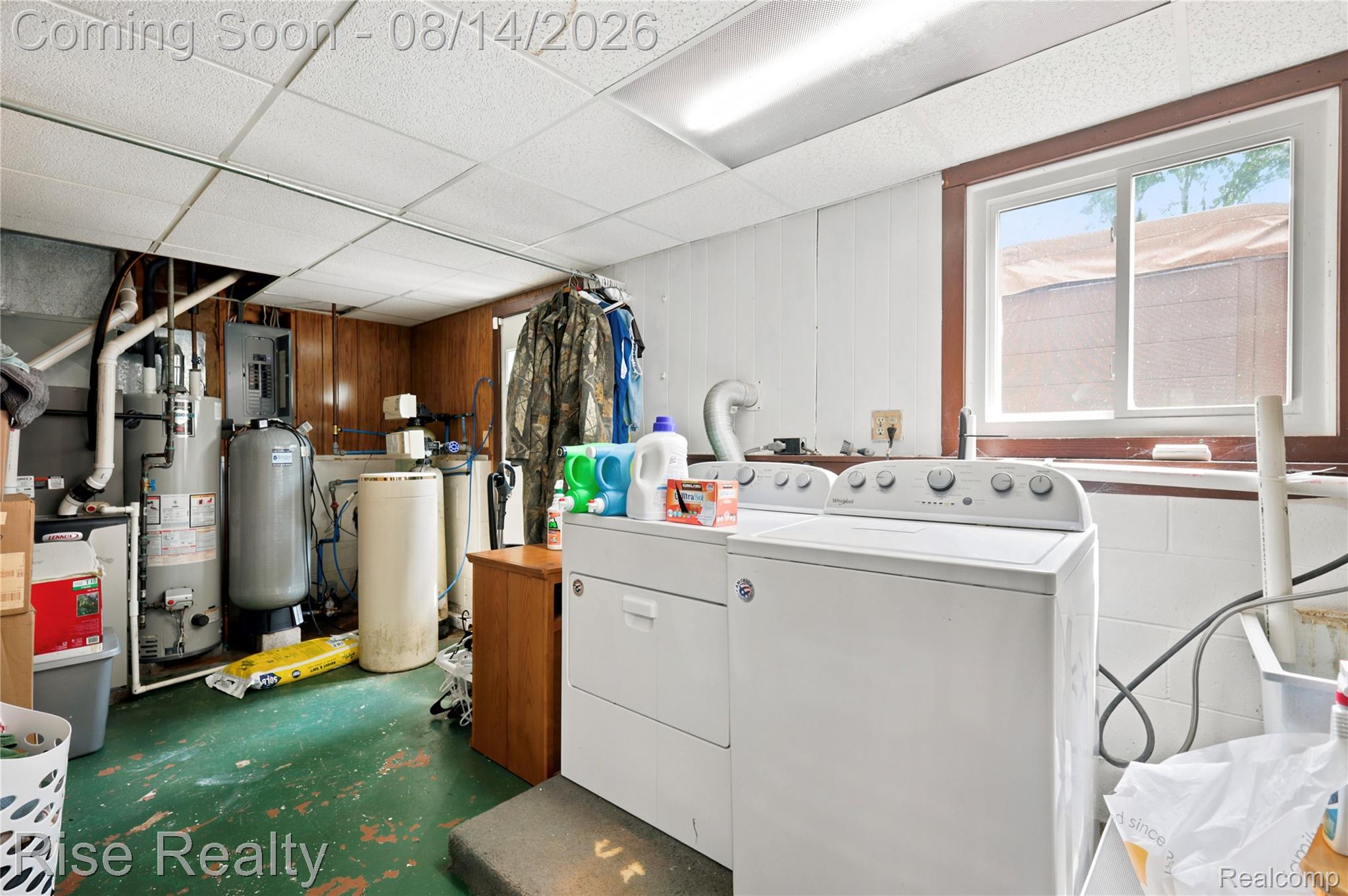 10215 West Frances Road Flushing, MI 48433 - Photo 23 of 31 Utility space featuring a washer and dryer, drop ceiling, and a window with wood trim