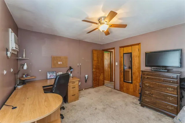 a bedroom with furniture and a flat screen tv