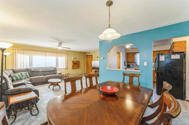 a view of a dining room with furniture wooden floor and chandelier