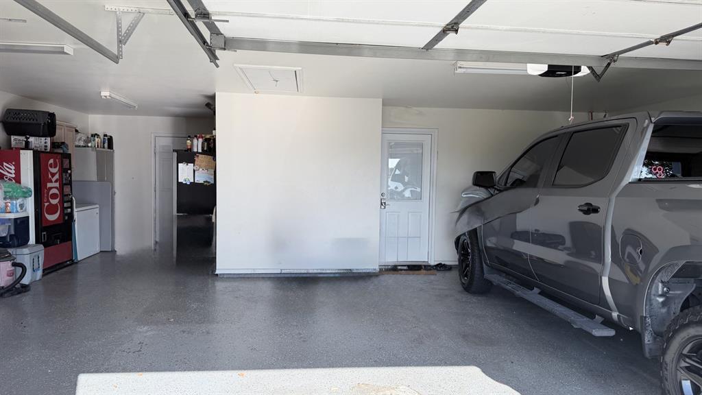 313 An County Road, Unit 2145 Palestine, TX 75801 - Photo 14 of 40 Concrete flooring with a speckled finish, white painted walls, and overhead fluorescent lighting