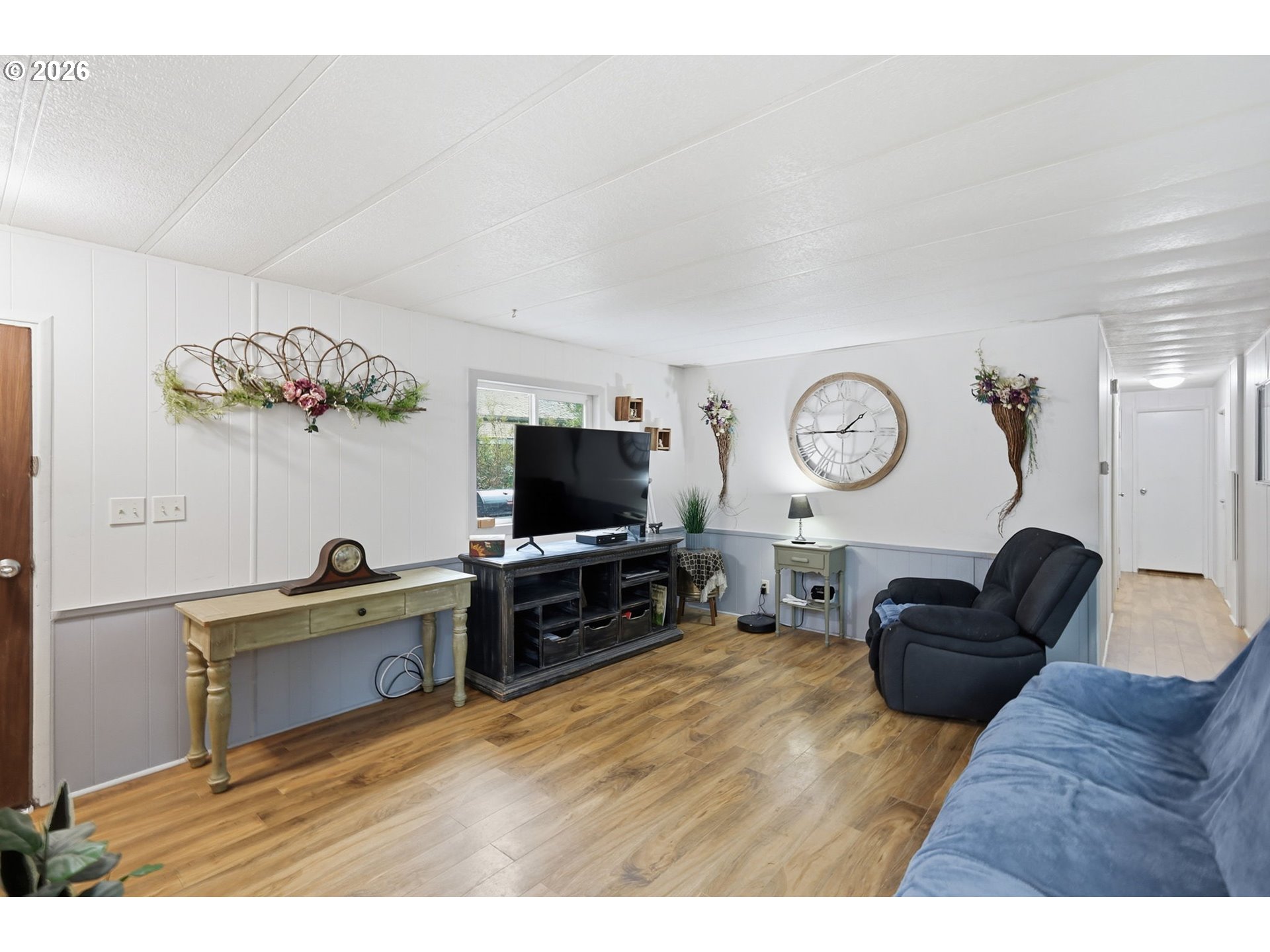 1600 Rhododendron Drive, Unit 76 Florence, OR 97439 - Photo 11 of 36 a living room with furniture and a flat screen tv