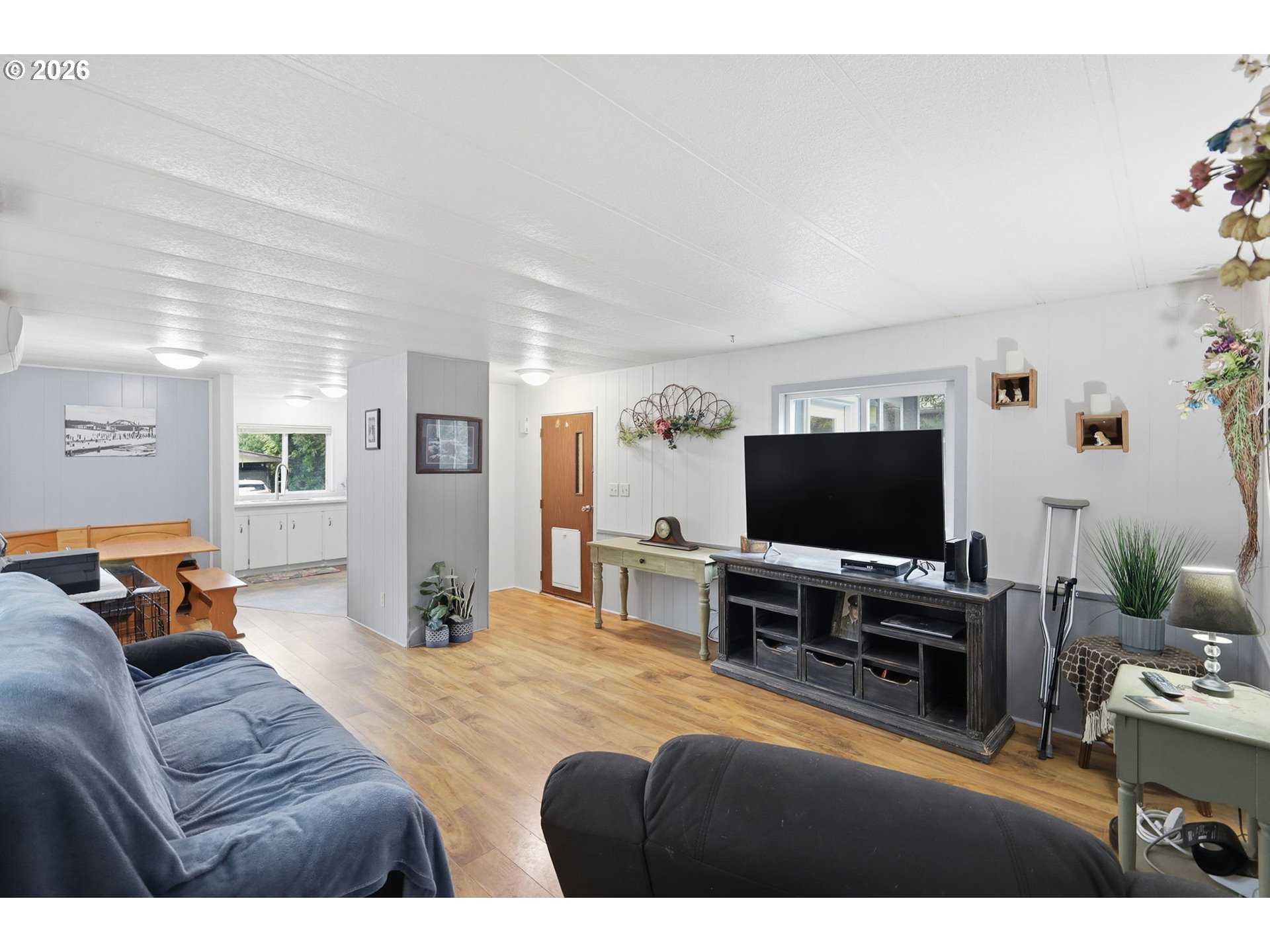 1600 Rhododendron Drive, Unit 76 Florence, OR 97439 - Photo 12 of 36 a bedroom with furniture and a flat screen tv
