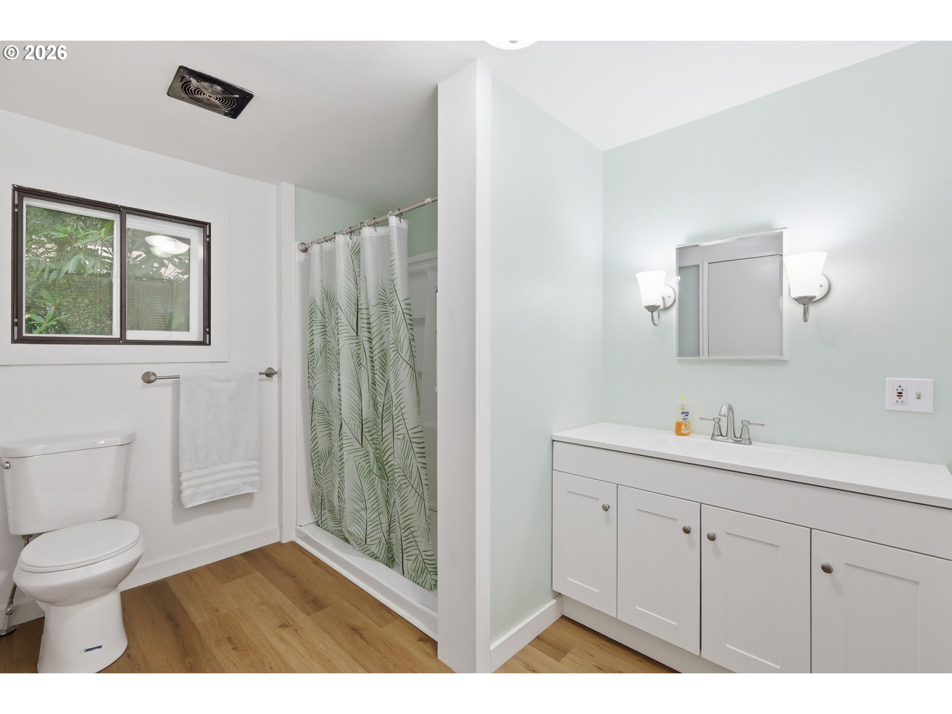 1600 Rhododendron Drive, Unit 76 Florence, OR 97439 - Photo 18 of 36 a bathroom with a toilet a sink a mirror a shower a vanity and window