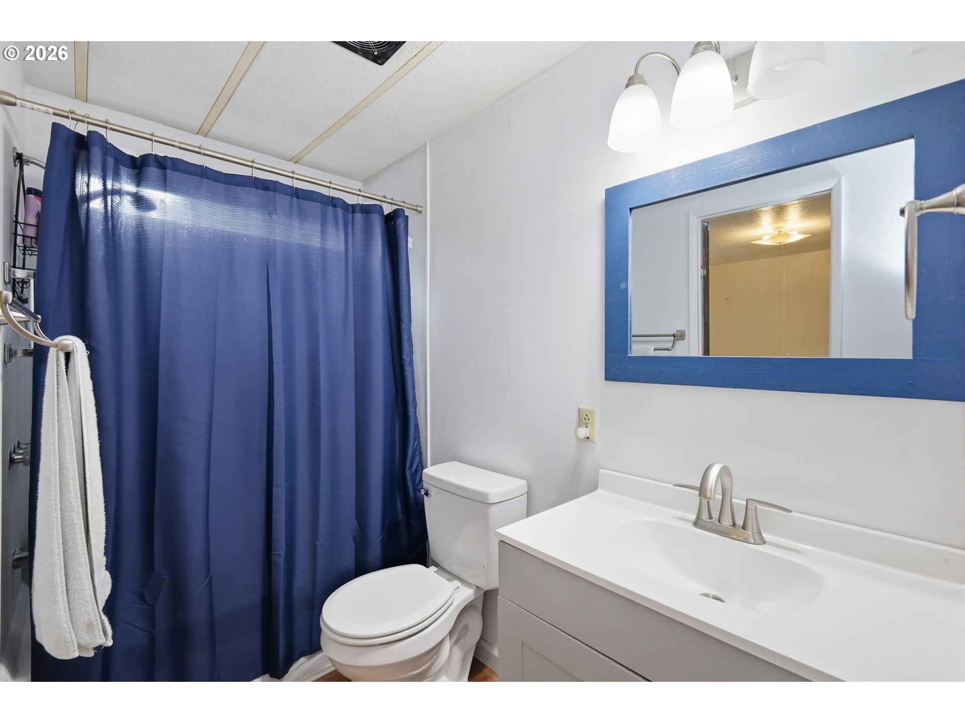 1600 Rhododendron Drive, Unit 76 Florence, OR 97439 - Photo 21 of 36 a bathroom with a sink a toilet and mirror
