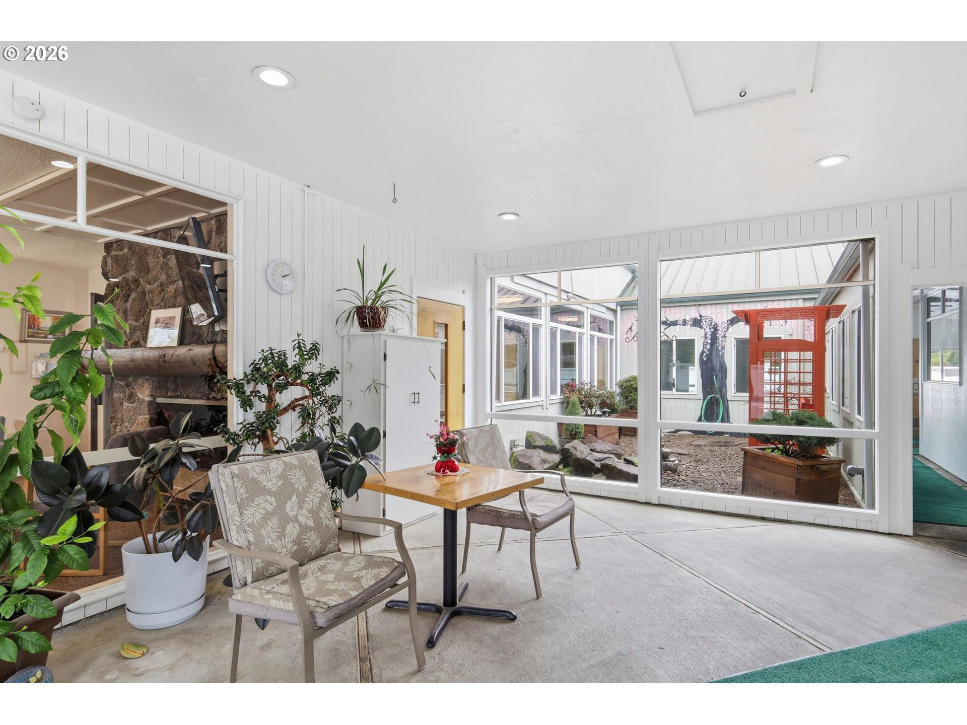 1600 Rhododendron Drive, Unit 76 Florence, OR 97439 - Photo 27 of 36 a living room with furniture and a dining table with kitchen view