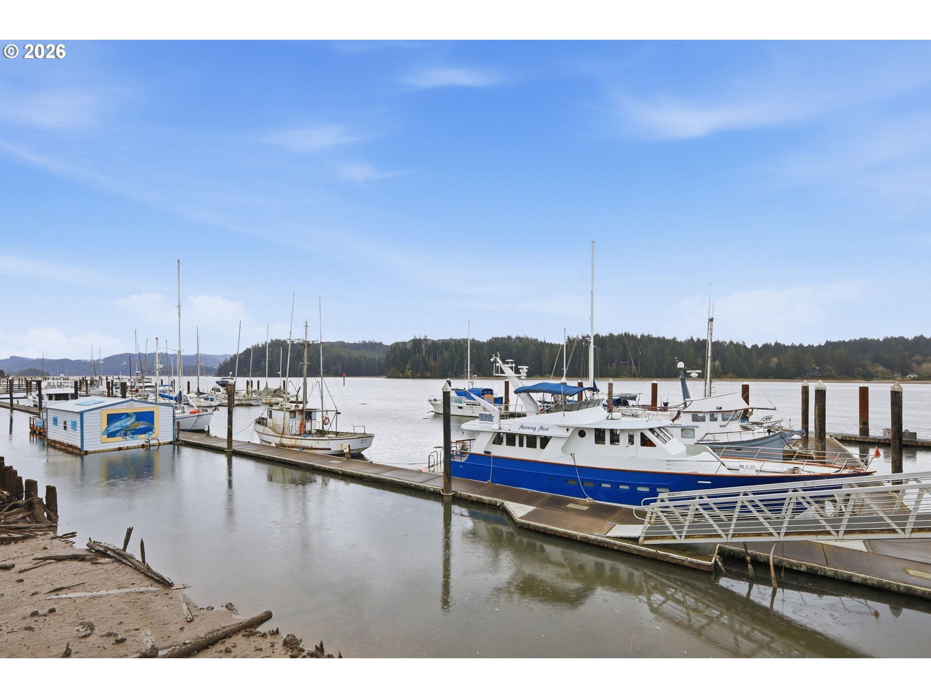 1600 Rhododendron Drive, Unit 76 Florence, OR 97439 - Photo 35 of 36 a view of a lake with chairs