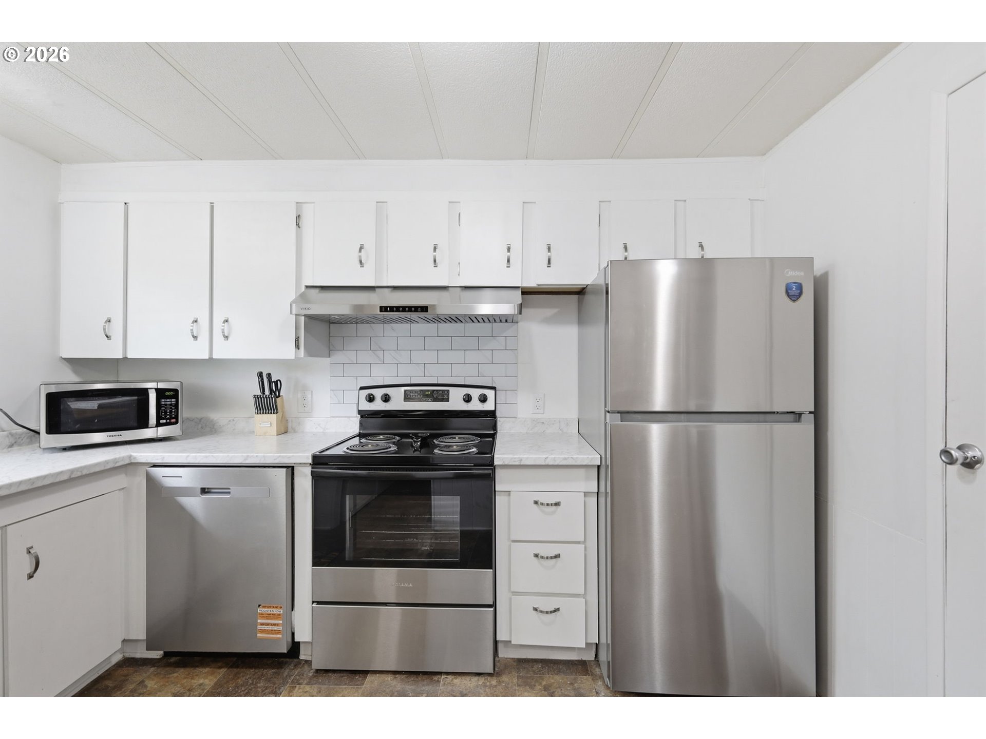 1600 Rhododendron Drive, Unit 76 Florence, OR 97439 - Photo 5 of 36 a kitchen with cabinets stainless steel appliances and a sink