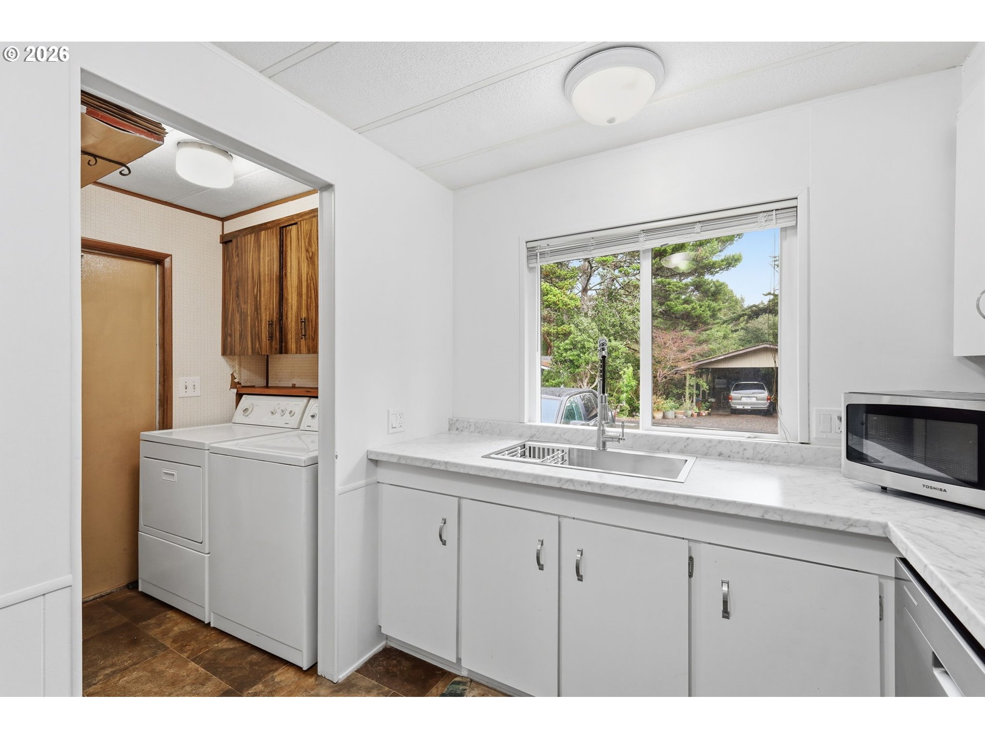 1600 Rhododendron Drive, Unit 76 Florence, OR 97439 - Photo 8 of 36 a kitchen with a sink cabinets and window