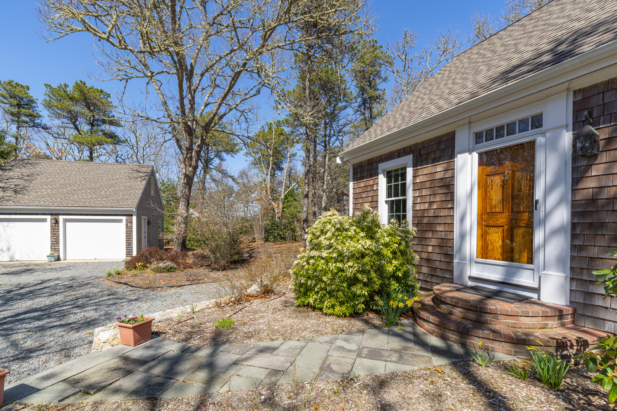 138 Namequoit Road Orleans, MA 02653 - Photo 1 of 50 a front view of a house with garden
