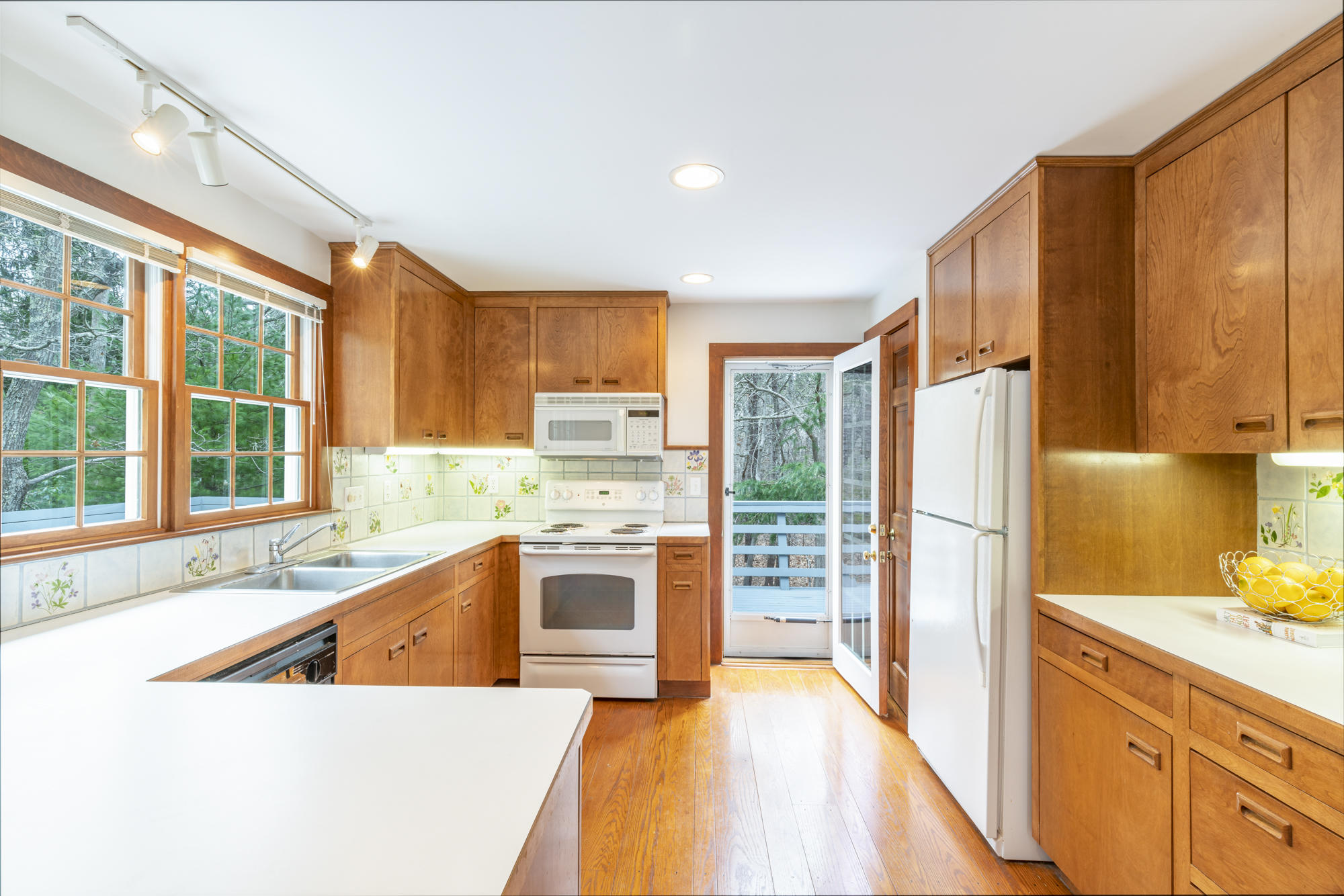 138 Namequoit Road Orleans, MA 02653 - Photo 11 of 50 a kitchen with stainless steel appliances granite countertop a refrigerator a stove and a sink with cabinets