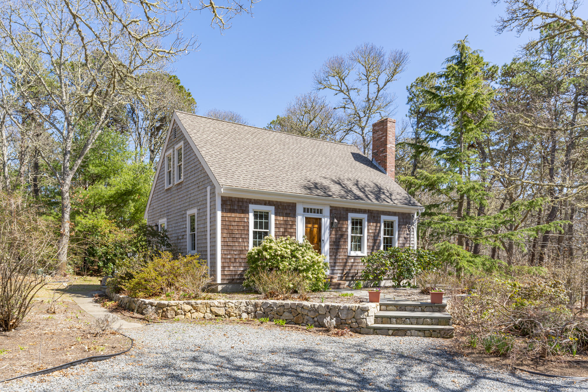 138 Namequoit Road Orleans, MA 02653 - Photo 2 of 50 a front view of a house with a garden
