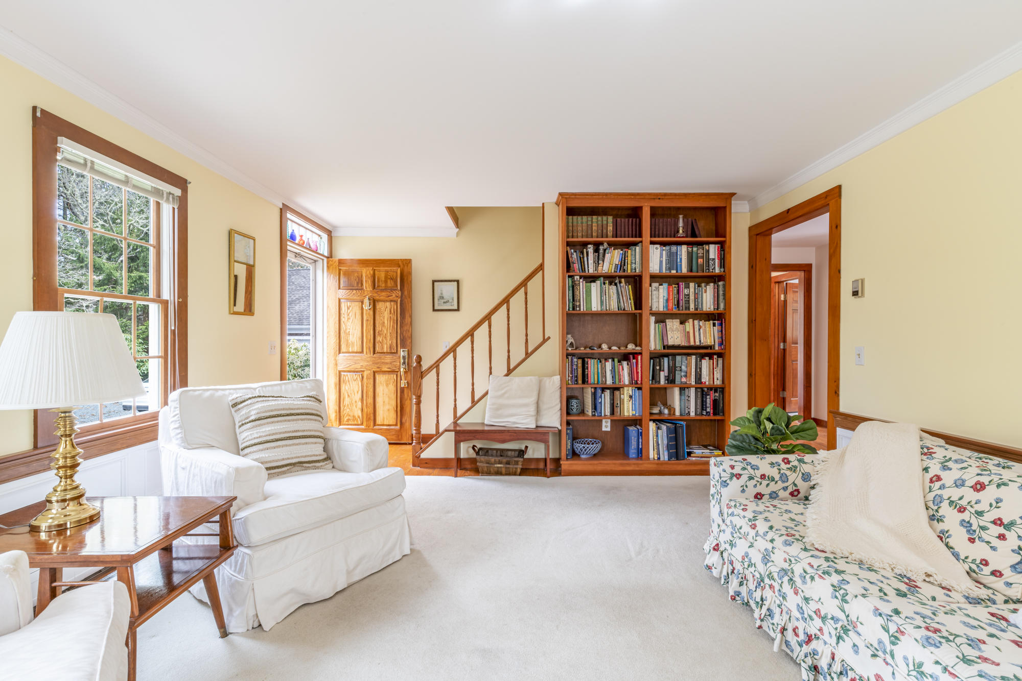 138 Namequoit Road Orleans, MA 02653 - Photo 8 of 50 a living room with furniture staircase and a large window
