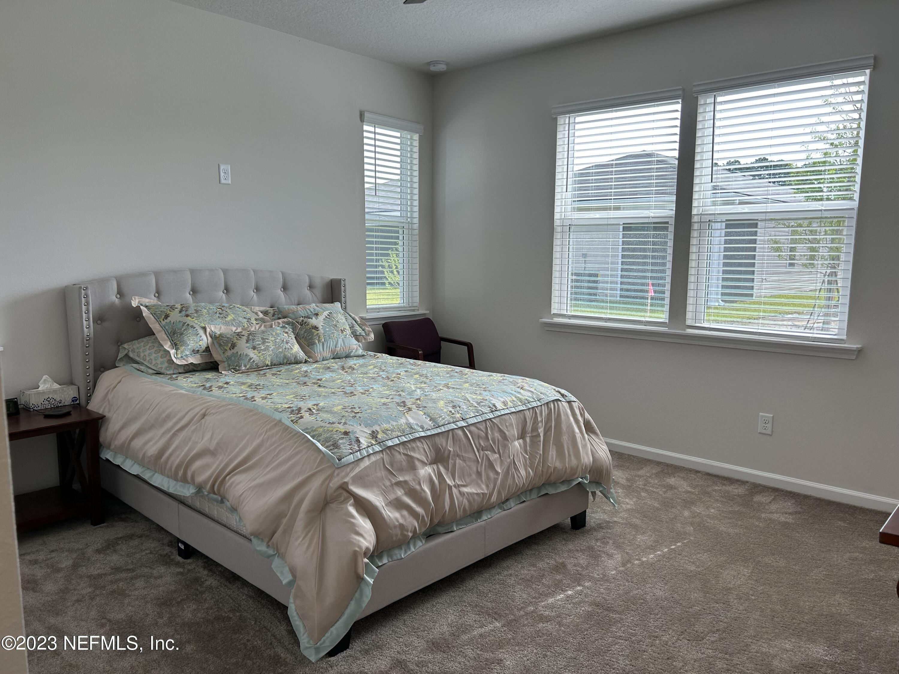 7109 Red Timber Road Jacksonville, FL 32244 - Photo 5 of 18 a bedroom with a bed and window