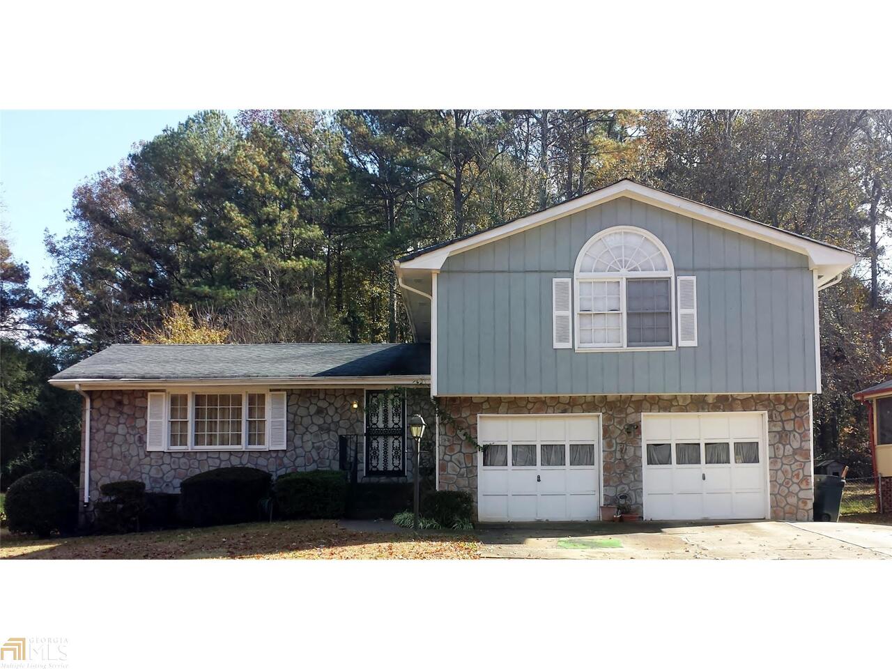 4705 Mercer Road Stone Mountain, GA 30083 - Photo 1 of 1 a front view of a house with a garden