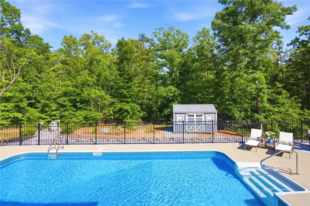 525 16th Circle Walhalla, SC 29691 - Photo 31 of 50 This private backyard oasis offers a sparkling pool and a charming shed for additional storage.