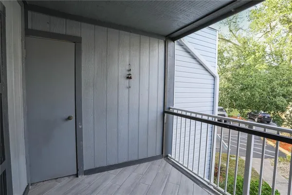 a view of a balcony with wooden floor