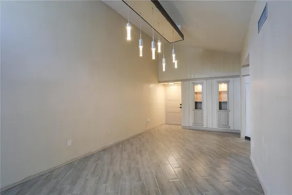 a view of an empty room with wooden floor