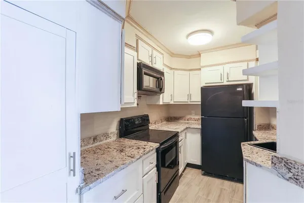 a kitchen with a refrigerator stove and sink
