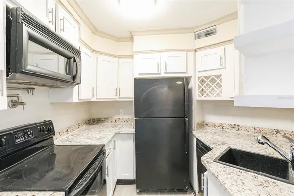 a kitchen with a refrigerator stove and sink