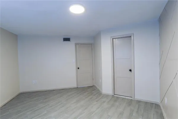 a view of an empty room and wooden floor