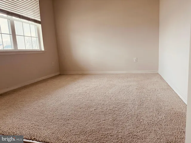 an empty room with a empty space and windows