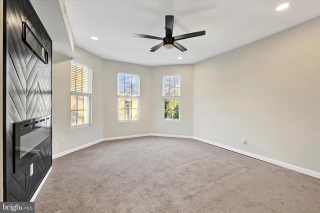 a view of a livingroom with a window and a ceiling fan