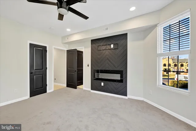 a view of an empty room with a ceiling fan