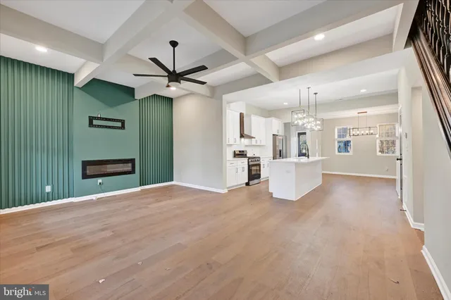 a view of a kitchen with a sink and a refrigerator