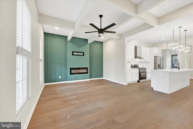 a view of a kitchen with refrigerator and a kitchen