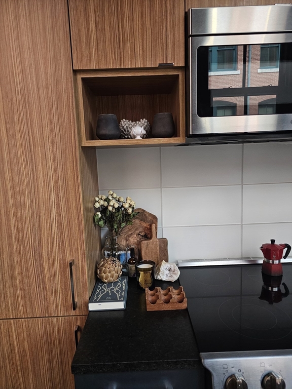 319 A Street, Unit 307 Boston, MA 02210 - Photo 13 of 25 a kitchen with a stove and a microwave