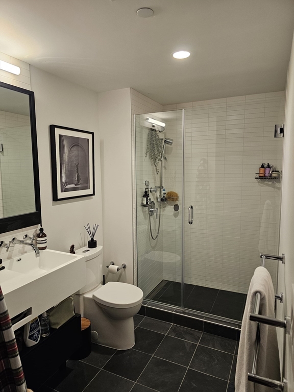 319 A Street, Unit 307 Boston, MA 02210 - Photo 15 of 25 a bathroom with a sink toilet and shower