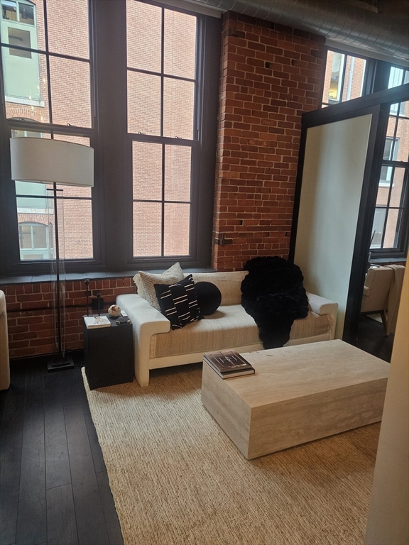 319 A Street, Unit 307 Boston, MA 02210 - Photo 19 of 25 a living room with furniture and a large window