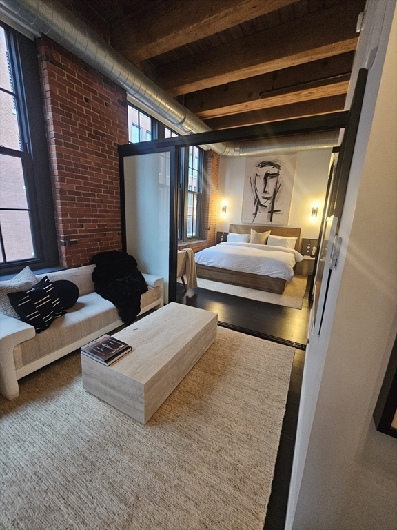 319 A Street, Unit 307 Boston, MA 02210 - Photo 2 of 25 a bedroom with bed and window