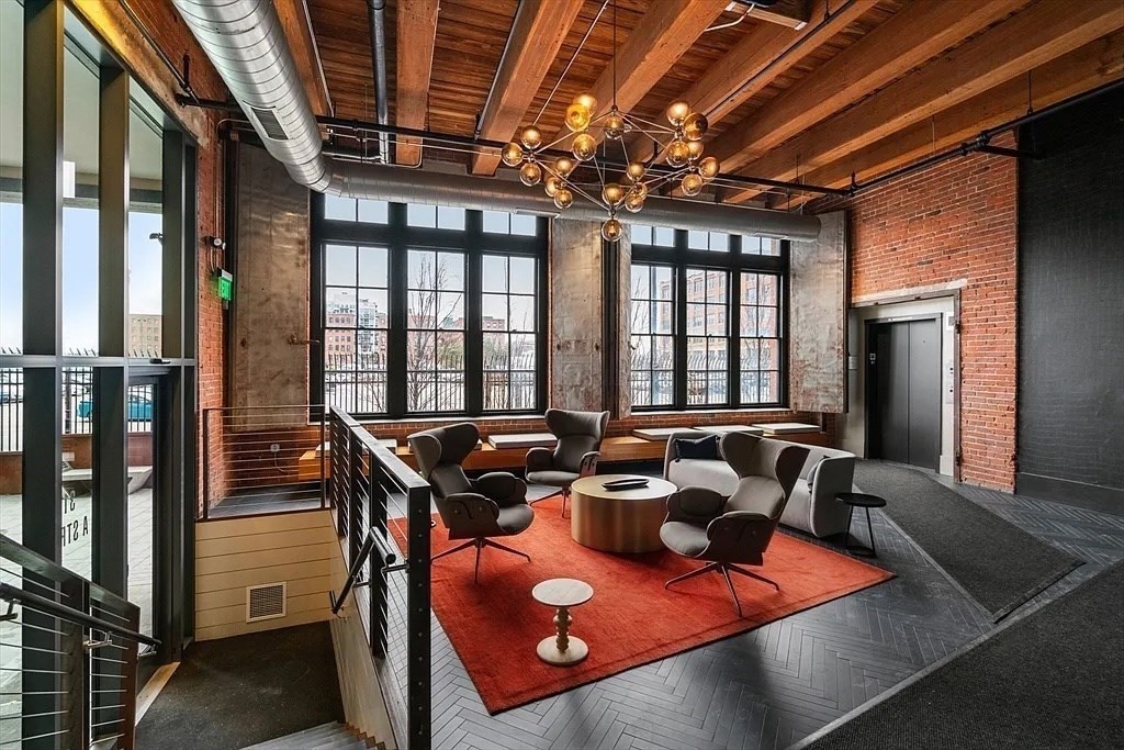 319 A Street, Unit 307 Boston, MA 02210 - Photo 22 of 25 a view of a dining room with furniture a chandelier and wooden floor