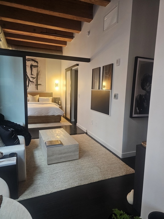 319 A Street, Unit 307 Boston, MA 02210 - Photo 6 of 25 a view of a hallway with couches and wooden floor