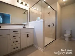 a bathroom with a shower sink and mirror