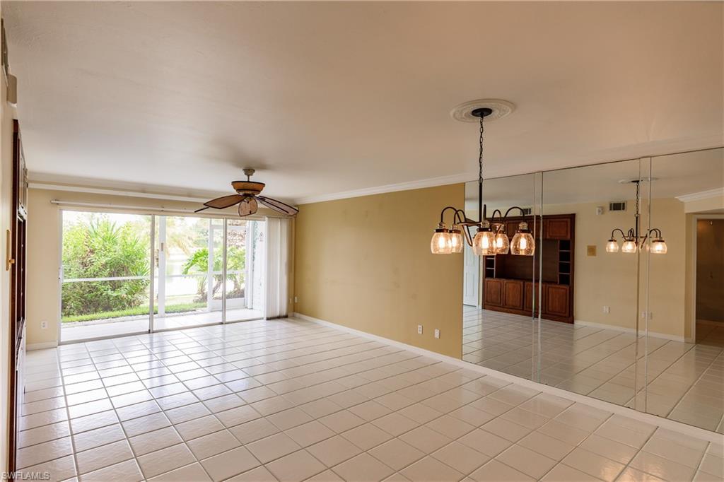 121 Gabriel Circle, Unit 1111 Naples, FL 34104 - Photo 11 of 34 a view of a room window and wooden floor