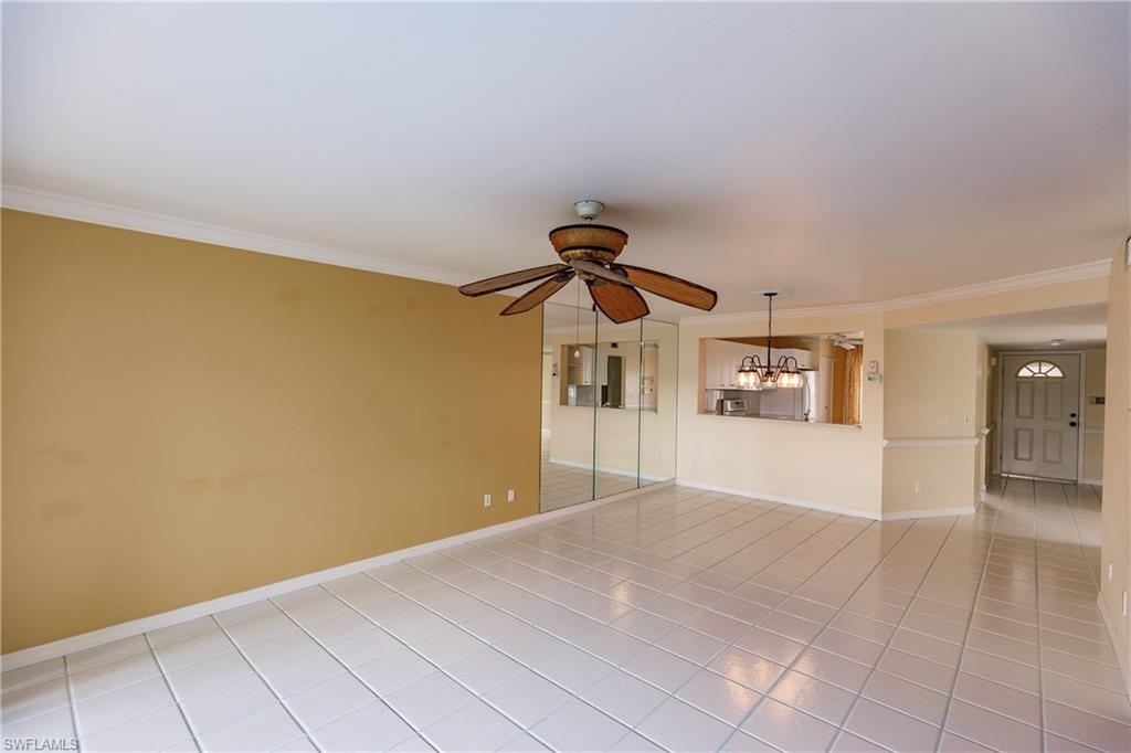 121 Gabriel Circle, Unit 1111 Naples, FL 34104 - Photo 12 of 34 a view of a livingroom with wooden floor and a ceiling fan