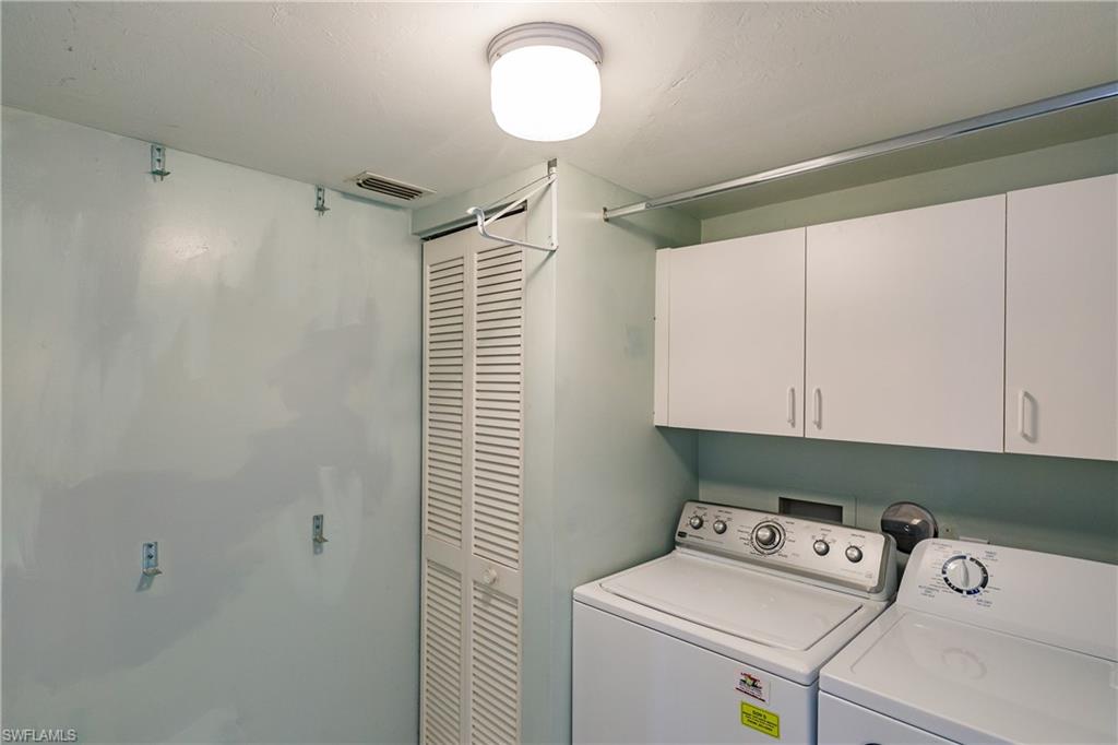 121 Gabriel Circle, Unit 1111 Naples, FL 34104 - Photo 14 of 34 a utility room with dryer and washer