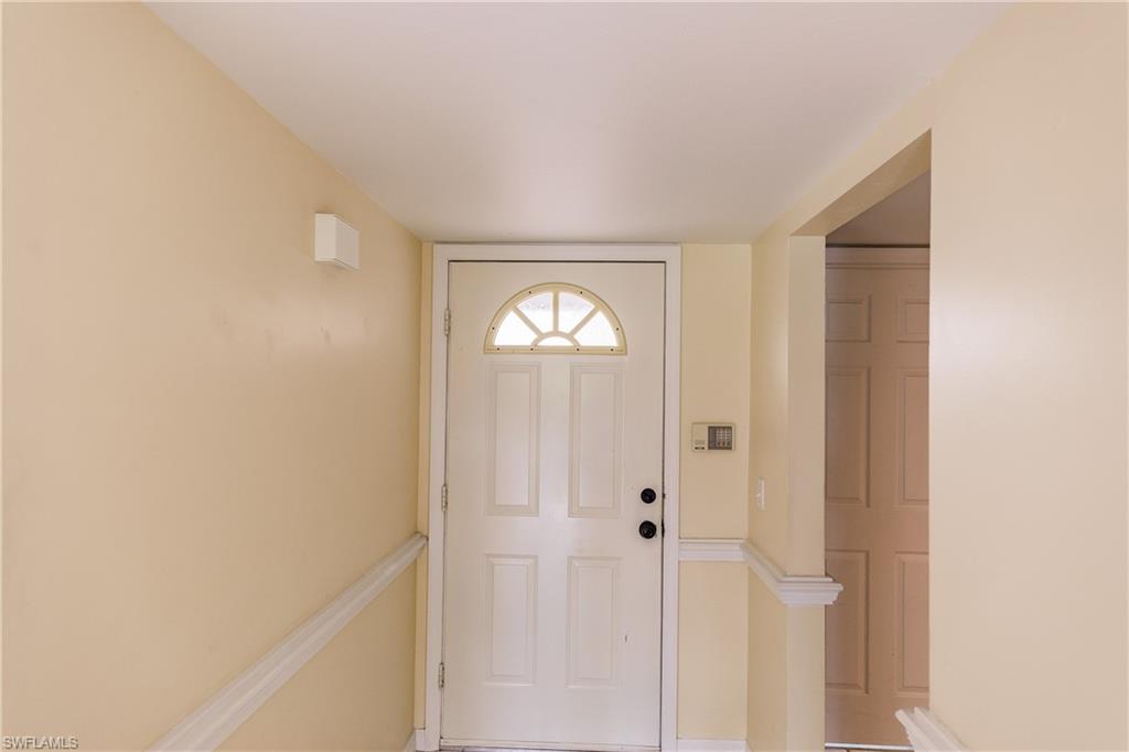 121 Gabriel Circle, Unit 1111 Naples, FL 34104 - Photo 2 of 34 a view of entryway with wooden floor