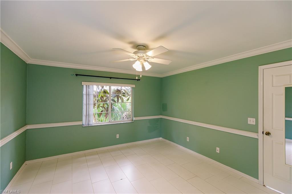 121 Gabriel Circle, Unit 1111 Naples, FL 34104 - Photo 25 of 34 a workspace with a window and a fan