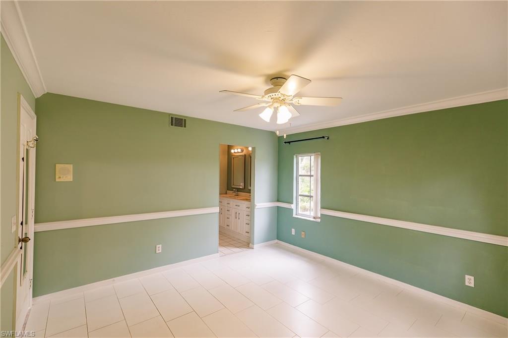 121 Gabriel Circle, Unit 1111 Naples, FL 34104 - Photo 26 of 34 a view of an empty room with window and chandelier fan