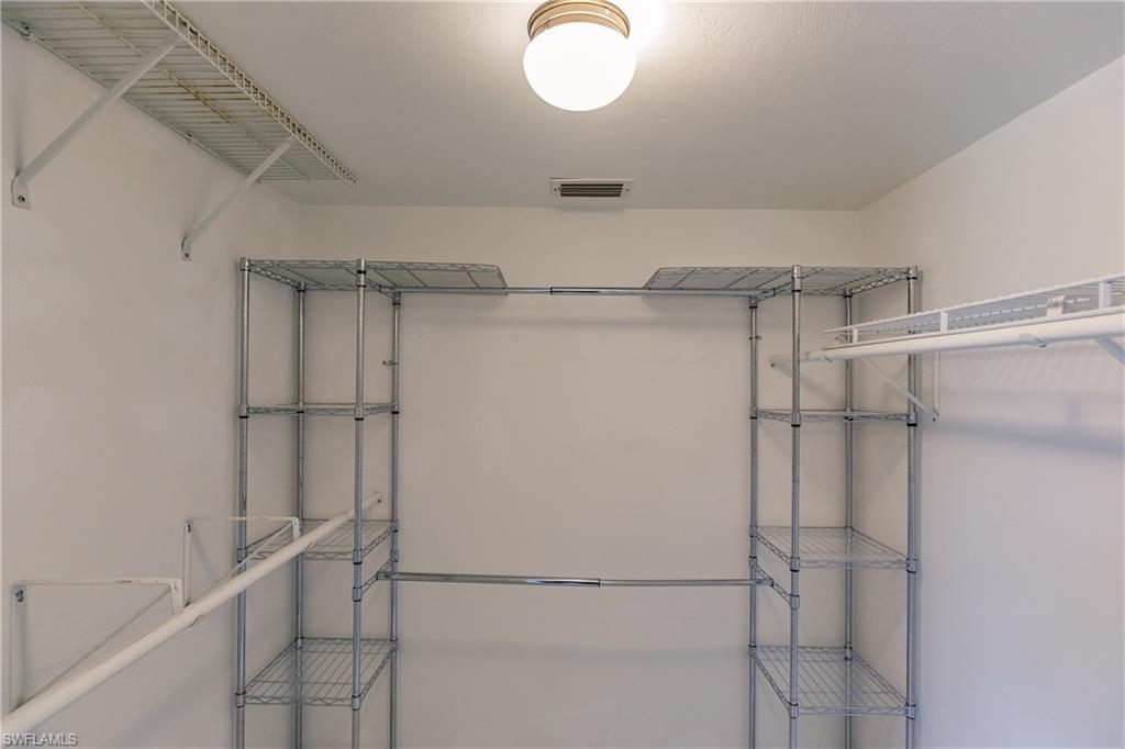 121 Gabriel Circle, Unit 1111 Naples, FL 34104 - Photo 27 of 34 a view of walk in closet