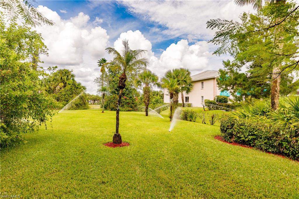 121 Gabriel Circle, Unit 1111 Naples, FL 34104 - Photo 28 of 34 a view of yard with swimming pool