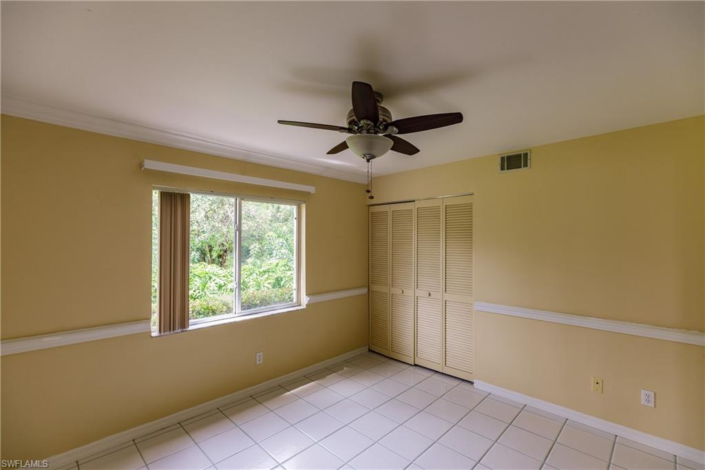 121 Gabriel Circle, Unit 1111 Naples, FL 34104 - Photo 30 of 34 a view of an empty room with a window