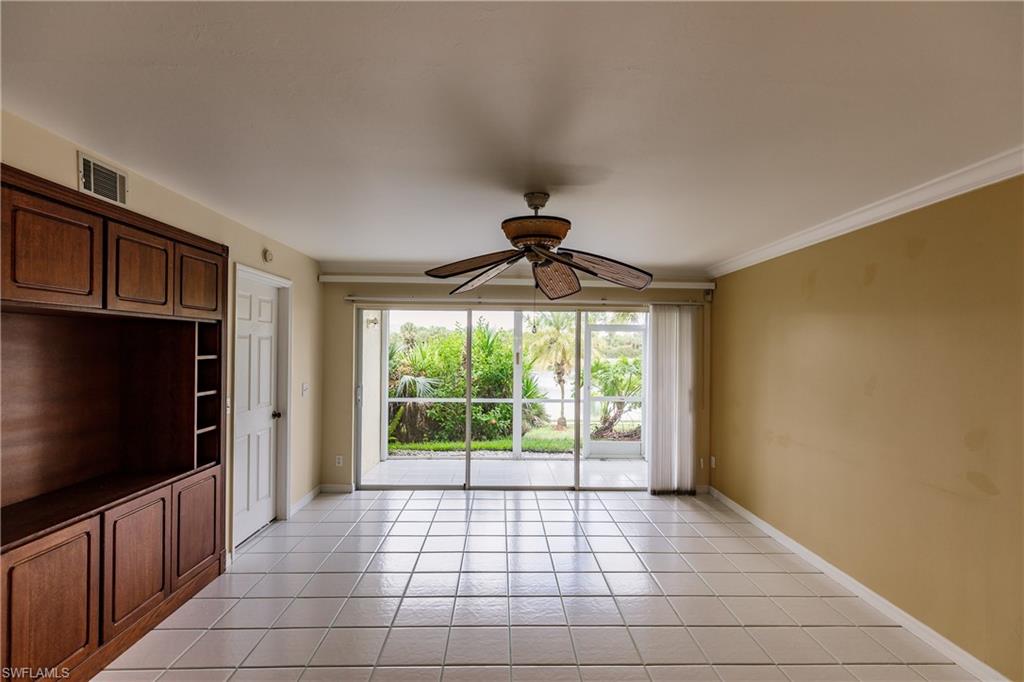 121 Gabriel Circle, Unit 1111 Naples, FL 34104 - Photo 3 of 34 a view of empty room with wooden floor and fan