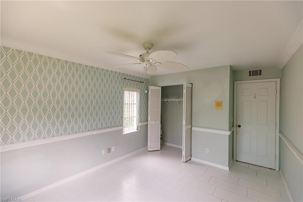 121 Gabriel Circle, Unit 1111 Naples, FL 34104 - Photo 6 of 34 wooden floor in an empty room with a window