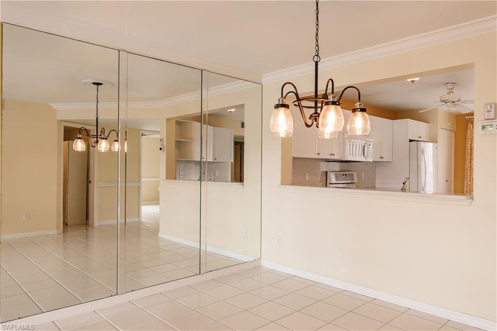 121 Gabriel Circle, Unit 1111 Naples, FL 34104 - Photo 8 of 34 a view of a kitchen with a refrigerator and microwave